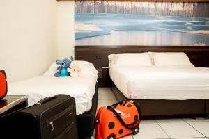 Postel nebo postele na pokoji v ubytování Hotel Pineta