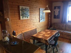 a living room with a table and a couch at Haus Seeberghof by Globalimmoservice in Millstatt