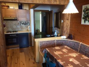 a kitchen with a couch and a table in a room at Haus Seeberghof by Globalimmoservice in Millstatt