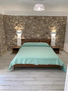 Postel nebo postele na pokoji v ubytování LA CASA DI PIETRA
