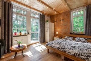 sypialnia z łóżkiem, stołem i oknami w obiekcie Apartamenty Pod Skocznią w mieście Karpacz