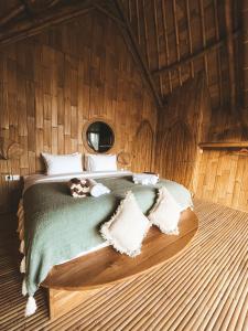 a bedroom with a bed in a wooden room at Kalma Bamboo Eco Lodge in Kuta Lombok