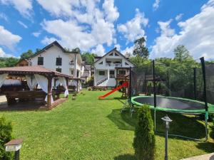 a yard with a playground with a trampoline at CASA Fratii MÂT in Moisei
