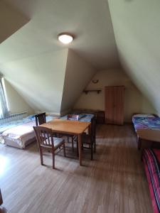 a room with a table and chairs in a attic at Pokoje na Sobczakówce in Zakopane