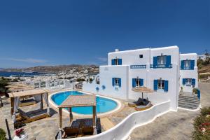 a villa with a swimming pool and a resort at Marisso Hotel in Mikonos