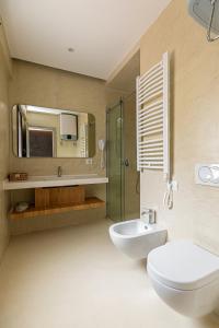 a bathroom with a toilet and a sink and a mirror at NOVUS ROOMS in Vlorë