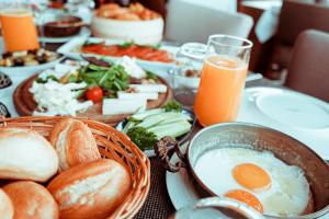 a table topped with breakfast foods and orange juice at Espina Hotel in Antalya