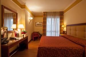 מיטה או מיטות בחדר ב-Il Chiostro