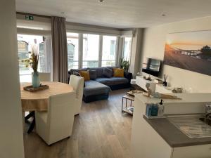 a living room with a couch and a table at ERNA in Blankenberge