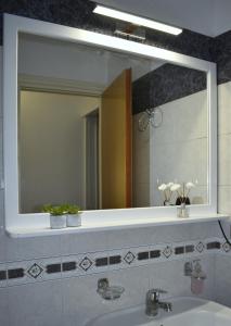 a bathroom with a large mirror and a sink at Portico Cozy Home in Kariá +49 photos