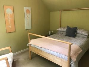 a bedroom with a bed with a wooden frame at Brylach Steading in Aberlour