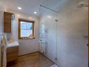 W łazience znajduje się szklana kabina prysznicowa i umywalka. w obiekcie Appartements Fortuna w mieście Pertisau