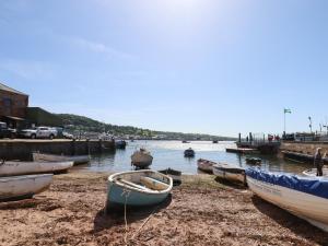 a group of boats sitting on the shore at Quayside Cottage in Teignmouth