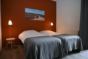 A bed or beds in a room at Drouwenerzand Hotel