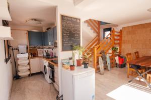 a kitchen with a chalkboard on the wall and a table at International Surf Camp ONLY SURF in Corralejo