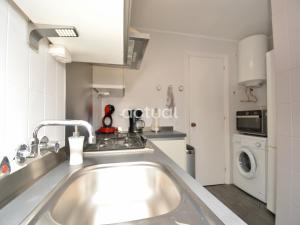 a kitchen with a sink and a washing machine at Fanals 4M in Platja d'Aro