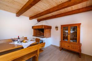 a dining room with a table and a fireplace at kuća za odmor ZARA in Stankovci