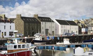 a group of boats docked in a harbor with buildings at No.4 Bignold in Wick