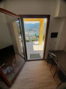 a room with a sliding glass door with a view of a patio at Finestra sul Golfo in Rapallo