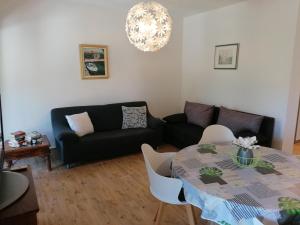 a living room with a table and a couch at Apartman Ilaria in Medulin