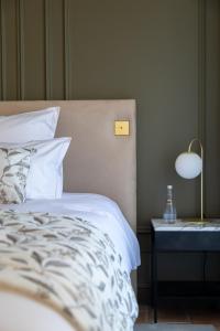 A bed or beds in a room at Artemisia - Domaine de Rochebois