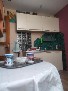 a kitchen with white cabinets and a table at Dom na Górce in Gorlice