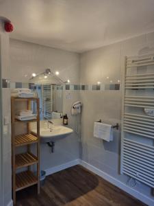 a bathroom with a sink and a mirror at Hôtel Vauban in Le Palais