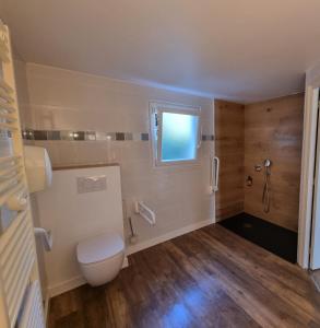 a bathroom with a toilet and a shower at Hôtel Vauban in Le Palais