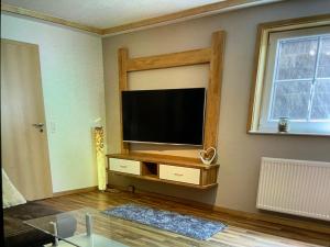 a living room with a flat screen tv on a wall at Moselweinlaub in Bruttig-Fankel