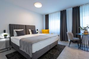 a bedroom with a large bed and a table and chairs at Apartments & Room Forest in Slunj +51 photos