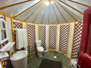 a small bathroom with a toilet and a sink at The Glamping Spot Kalam in Kalām +67 photos