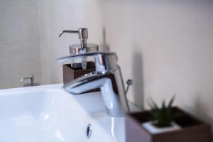 a bathroom sink with a chrome faucet on it at Sziklai Apartman in Veszprém