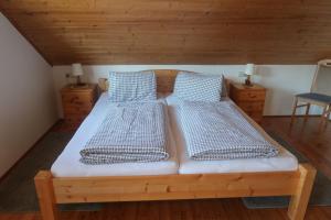 two twin beds in a room with wooden ceilings at Ferienwohnung Josy in Sankt Kanzian