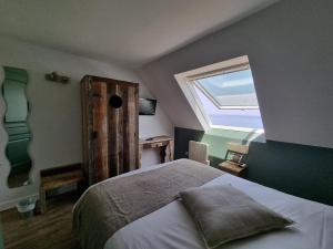 a bedroom with a large bed and a window at Hôtel Vauban in Le Palais