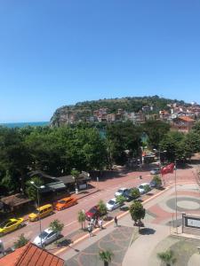 a city with cars parked in a parking lot at bedesten otel in Amasra