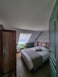 a bedroom with a large bed and a window at Hôtel Vauban in Le Palais