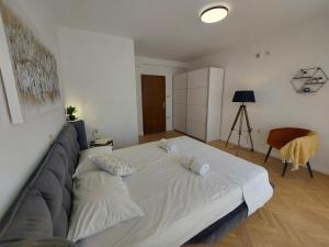 a bedroom with a bed with two pillows on it at Apartments Fugosic in Punat