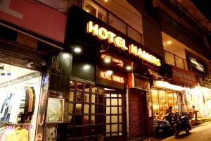 a store with a motorcycle parked outside at night at Hotel Hamers International in Mussoorie