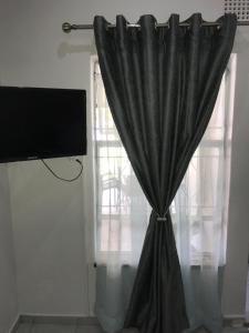 a black curtain in front of a window at Pomona Lodge in Kempton Park +12 photos