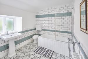 a bathroom with a sink and a tub and a toilet at Poets Cottage in Skinningrove +35 photos