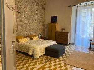 a bedroom with a bed and a checkered floor at Priçosa Perfect Apart Cyclists&Travellers in Girona