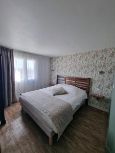 a bedroom with a large bed in a room at Hôtel Vauban in Le Palais