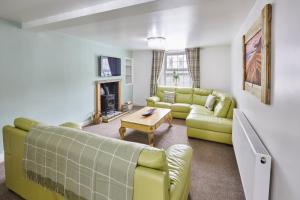 a living room with a couch and a table at Poets Cottage in Skinningrove