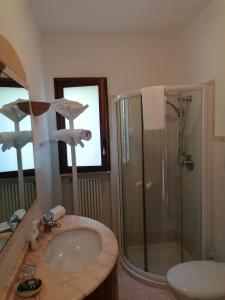 a bathroom with a sink and a shower and a mirror at Solmar Casa Vacanze in Monopoli