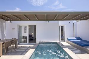 a villa with a swimming pool and a patio at White Holidays Project in Tinos Town
