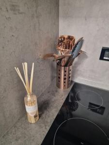 a vase filled with cooking utensils on a counter at In pieno centro storico Antico Quadrilatero in Bologna