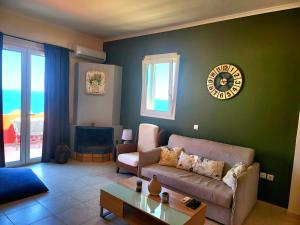 a living room with a couch and a table at Helios Apartments - Beach of Lachania Rhodes in Lakhania