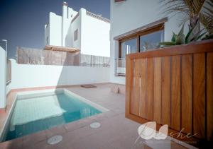 a swimming pool in the middle of a room at PUSHE Village Playa Granada Beach & Golf 1 in Motril