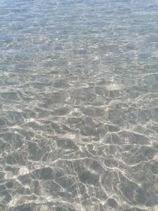 a large body of water with rocks in it at Solmar Casa Vacanze in Monopoli