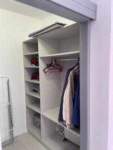 a walk in closet with white shelves at Pearl Sunshine Appartments in Primorsko